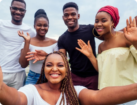 Smiling young people waving at the camera